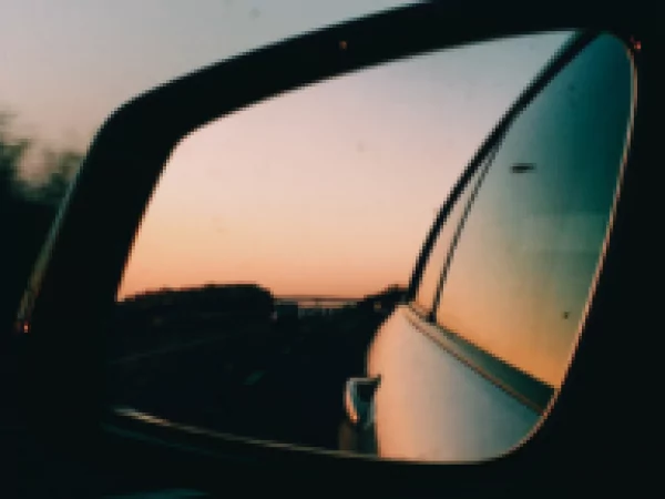 A part of car with sunrise